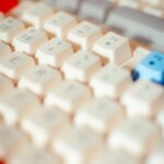 Detailed shot of a mechanical keyboard featuring Asian character keycaps, emphasizing tech elements.