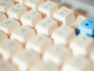Detailed shot of a mechanical keyboard featuring Asian character keycaps, emphasizing tech elements.