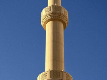A stunning minaret reaching into a clear blue sky in Dubai, UAE.