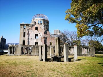 Captured at Hiroshima Peace Memorial Park showcasing the iconic Atomic Bomb Dome under a clear blue sky.