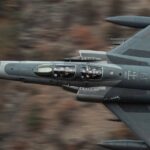 High-speed Turkish military jet flying over rugged terrain, showcasing aviation prowess.