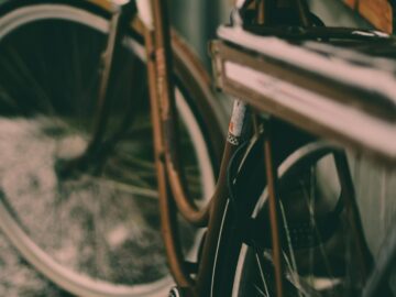 A close-up view of a retro-styled bicycle wheel with a blurred background, highlighting vintage aesthetics.