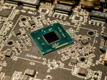 Detailed view of a microchip on a printed circuit board, showcasing electronic components.