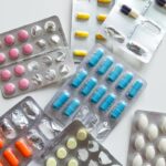 Various colorful medicine tablets in blister packs, emphasizing healthcare and pharmaceutical concepts.