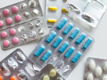Various colorful medicine tablets in blister packs, emphasizing healthcare and pharmaceutical concepts.