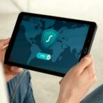 Person holding tablet with VPN connection screen for secure internet browsing.