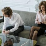 A couple in a therapy session reflecting and discussing their relationship challenges. Indoors, soft mood.