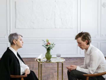 A therapist and patient engage in a private counseling session in a serene office setting.