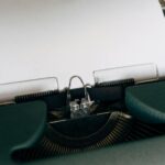 Close-up of a classic vintage typewriter with blank paper ready for typing.