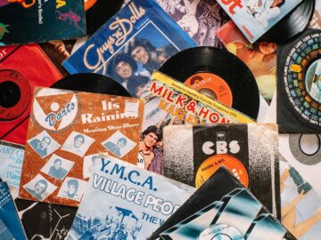 A flat lay of vintage vinyl record covers showcasing 70s and 80s music nostalgia.