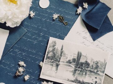 Elegant vintage still life featuring letters, ribbon, and floral elements creating nostalgic ambiance.