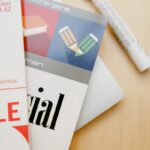 Close-up shot of Spanish language books and a marker on a wooden surface.