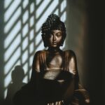 woman in black dress sitting on chair
