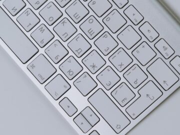 Close-up of a white computer keyboard with Cyrillic letters for communication and technology use.