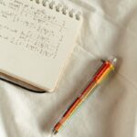 Handwritten math formulas on a notepad with a colorful pen on a white background.