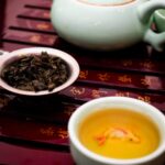 Elegant display of a Chinese tea ceremony with a teapot, teacup, and loose tea.