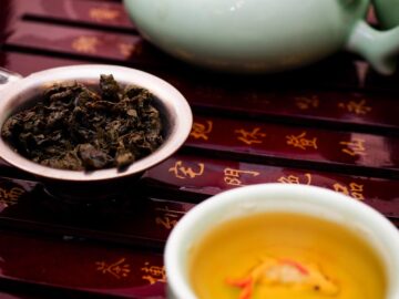 Elegant display of a Chinese tea ceremony with a teapot, teacup, and loose tea.