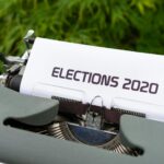 Close-up of a typewriter typing 'Elections 2020' outdoors.