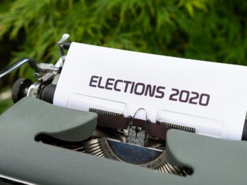 Close-up of a typewriter typing 'Elections 2020' outdoors.
