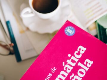 An inviting scene with Spanish grammar notebook and coffee, perfect for study sessions.