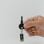 Close-up of a hand holding a key and USB with copyspace.