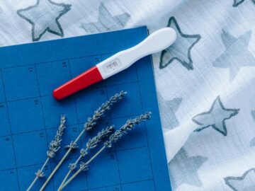A pregnancy test with blue calendar and lavender symbolizes planning and fertility.
