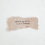 Hand-typed inspirational quote on a textured paper with a minimalist background.