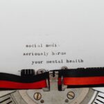 Close-up of a typewriter with the message 'social media seriously harms your mental health'.
