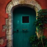 green door on a red concrete house
