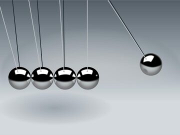 Dynamic illustration of Newton's Cradle showing motion and reflection concepts in physics.