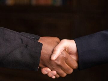 Close-up of a formal handshake between professionals, symbolizing agreement and partnership.
