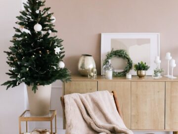 Stylish Christmas tree and gifts in a modern minimalist living room setting.