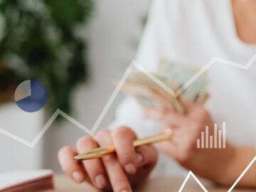 Woman using calculator with financial graph overlay, indicating data analysis and finance planning.