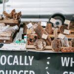 Different delicious fresh breads and loaves placed on wooden trays in small street bakery