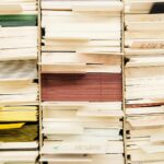 Close-up view of stacked documents in various colors organized in a file system.