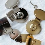 Detailed flat lay of different colored metallic locks and a key on a textured background.