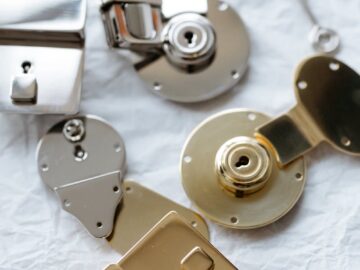 Detailed shot of different metal locks and a key on a textured surface, highlighting security.