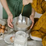 Mother and child mixing dough in a bowl, symbolizing family togetherness and home baking.