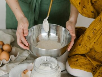 Mother and child mixing dough in a bowl, symbolizing family togetherness and home baking.