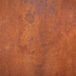 Close-up of a textured rusty metal surface, ideal for backgrounds or grunge design.