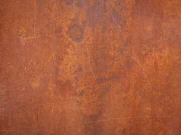 Close-up of a textured rusty metal surface, ideal for backgrounds or grunge design.