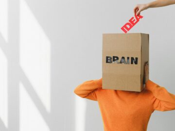 Surreal image of a person with a cardboard brain, symbolizing idea and intellect.