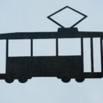 Silhouette of a tram sign symbolizing public transportation, isolated on white.