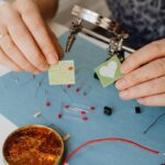 A detailed close-up of hands assembling electronics with circuit boards and soldering.