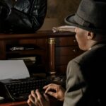 A classic noir scene depicting a detective typing on a vintage typewriter.