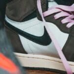 Detailed close-up of a stylish Nike sneaker showcasing unique pink laces and modern design.