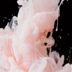 Stunning capture of pink ink swirling in water, creating an artistic and fluid abstract design.