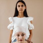 Two women showing support and care during illness, emphasizing friendship.