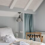 A tastefully decorated hotel room featuring elegant interior design with a cozy bed and stylish decor.