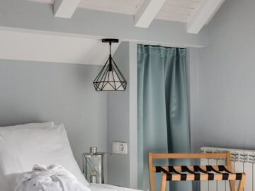 A tastefully decorated hotel room featuring elegant interior design with a cozy bed and stylish decor.